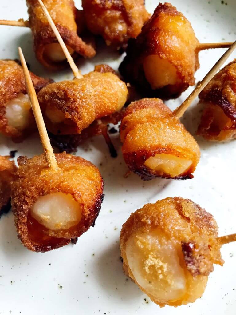 Perfect for holiday entertaining and game day!  These sweet yet spicy snacks are a great appetizer.  Use pork or turkey bacon.  The glaze of brown sugar and mustard caramelizes for a delicious app!  Three Olives Branch | Bacon Wrapped Waterchestnuts | www.threeolivesbranch.com
