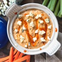 Top view of Buffalo Wing Hummus in a bowl with dippers around it