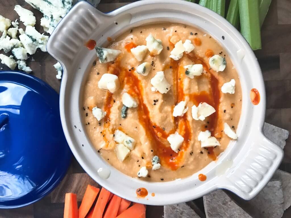 Less than 10 minutes, this hummus is a great healthy snack or appetizer for your big game! Fast and easy to make, full of protein. A simple dish to make in advance. Vegetarian, vegan friendly, perfect for football and Super Bowl parties. Buffalo Wing Hummus | Three Olives Branch | www.threeolivesbranch.com