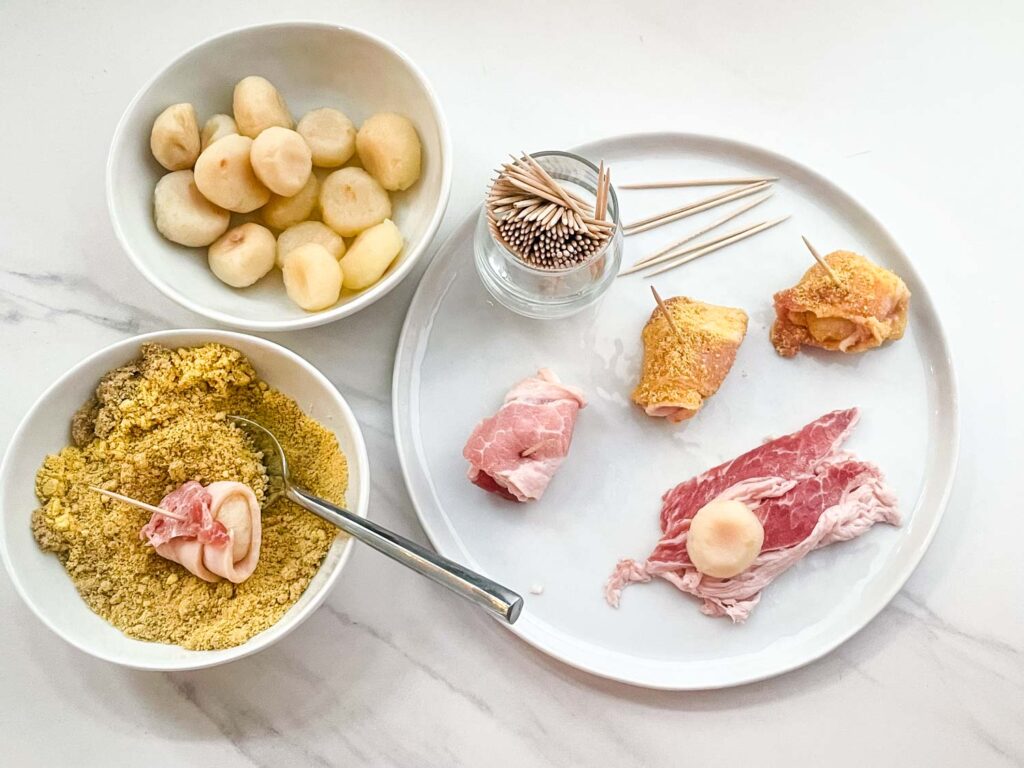 The Bacon Wrapped Water Chestnuts being made with a bowl of the sugar mixture on a counter