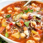 Pin of Italian Minestrone Soup in a white bowl with title at top.