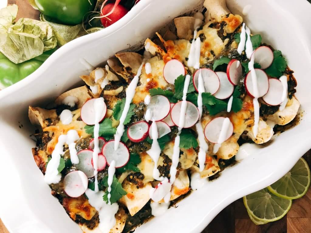 Top view of Roasted Poblano Salsa Verde Green Enchiladas with Chicken in a white dish