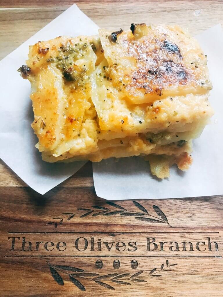 A perfect side dish for any event or holiday. We make these every Easter! A twist on a classic dish by using broccoli. Great to make ahead and bake day-of. Vegetarian. Broccoli Cheese Scalloped Potatoes | Three Olives Branch | www.threeolivesbranch.com