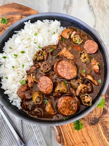 Top view of Authentic Chicken and Smoked Sausage Gumbo in a gray bowl with rice