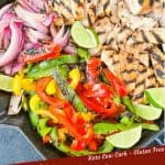 Pin image for Citrus Chicken Fajitas on the Grill in a skillet after they were grilled and cut up with some limes