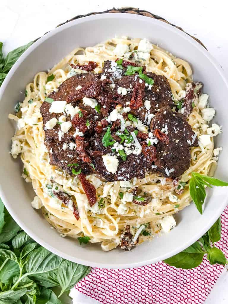 Top view of a large bowl of Copycat Olive Garden Steak Gorgonzola Alfredo