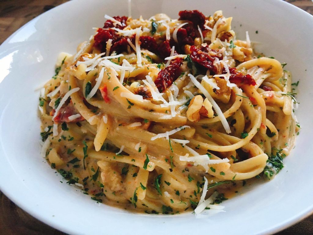 This quick and easy pasta is a great alternative when you want something a little different. A Parmesan cream sauce is the base for letting the walnuts and sun-dried tomatoes shine. Plus it is a great way to use up some of those pantry ingredients! Add some sausage or chicken for the meat lovers. | Three Olives Branch