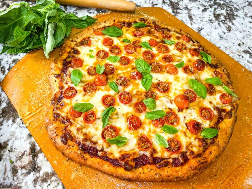 Caprese Pizza on a pizza peel after cooking