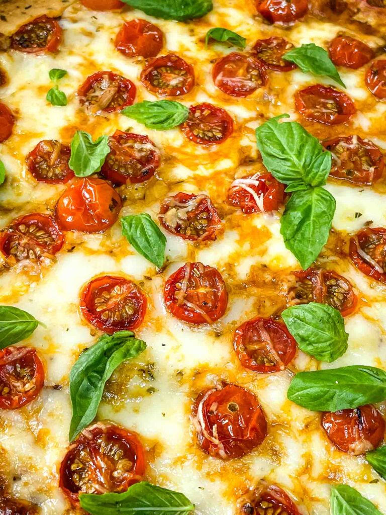 Close up of the tomatoes and basil on cheese