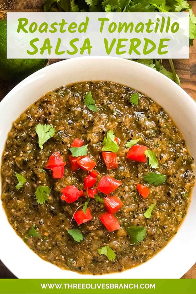 Pin of Roasted Tomatillo Salsa Verde in a white bowl with tomatoes and cilantro as a garnish. Title at top