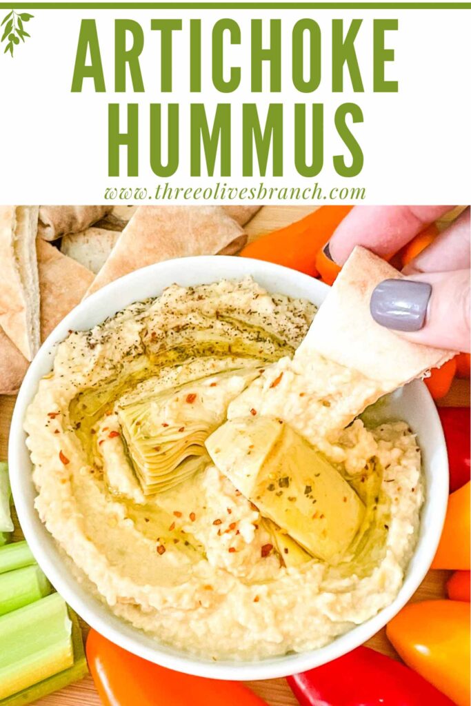 Pin of a hand dipping pita into Artichoke Lemon Hummus with title at top