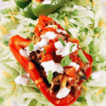 Pin of Beef Taco Stuffed Peppers sitting on lettuce with title