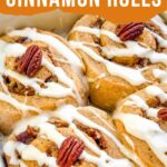 Pin of Pumpkin Spice Cinnamon Rolls with Maple Cream Cheese Glaze in a baking dish with title.