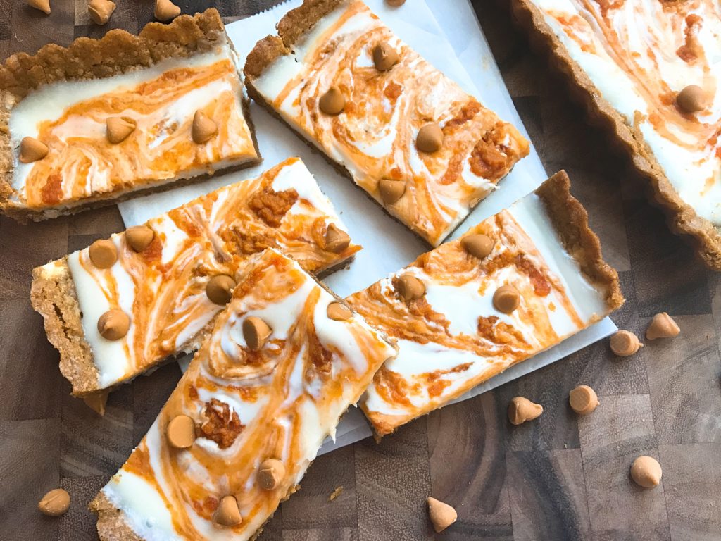 This fast and easy tart dessert recipe is perfect for busy moms and families living an on-the-go lifestyle! Just a few simple steps and this flavorful vegetarian tart will be ready to go. Perfect comfort food for fall and Thanksgiving baking! Cookie dough crust with a cream cheese filling, pumpkin puree, and butterscotch chips. Pumpkin Spice Butterscotch Tart | Three Olives Branch | www.threeolivesbranch.com #pumpkinspice #BakeHolidayGoodness #ad