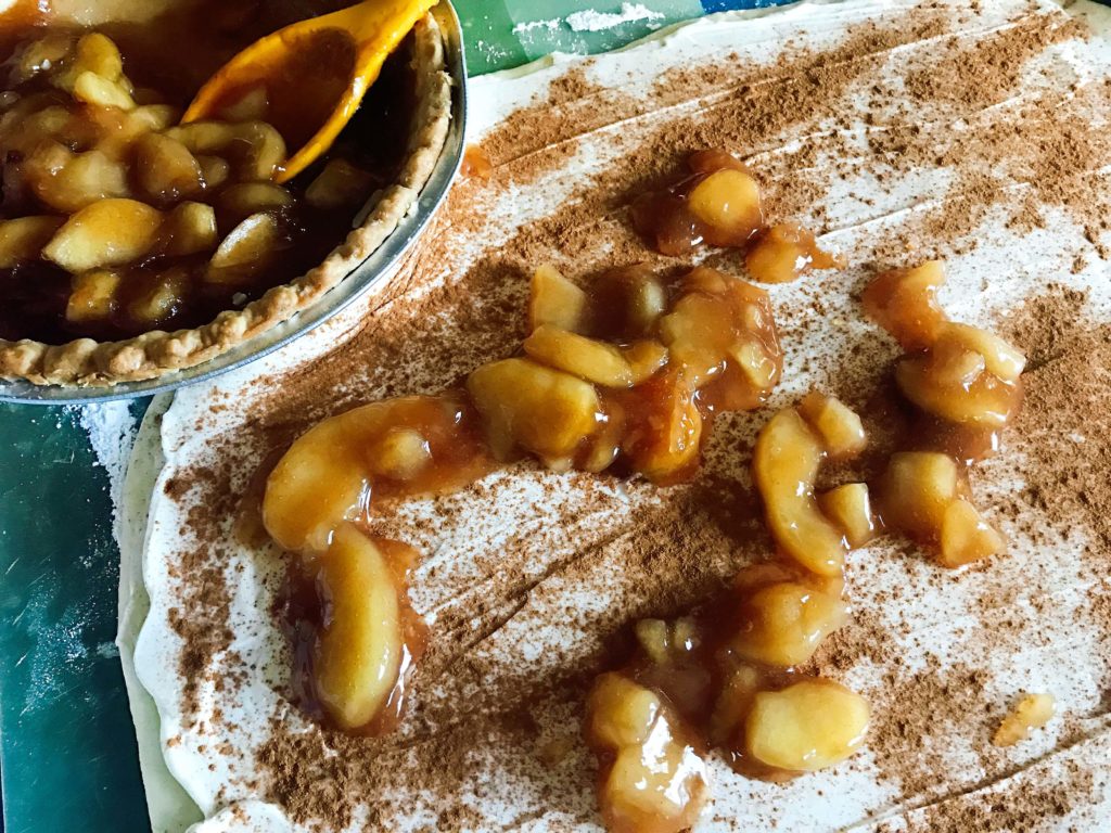 A fun dessert or breakfast item that features apple pie! Make it in advance for a fast and easy brunch or dessert. Vegetarian, kid friendly, and perfect for the holiday season. Cream cheese glaze and pie crumble on top. Featuring Marie Callender's Pie and Reddi-wip cream. Apple Pie Sweet Roll Log | Three Olives Branch | www.threeolivesbranch.com