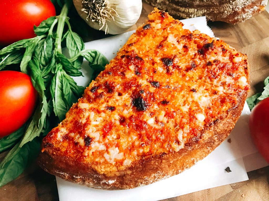 Ready in less than 10 minutes, this Pan con Tomate Garlic Bread is inspired by the classic Pan con Tomate dish in Spain. Tomato and garlic are the stars of this unique bread, perfect as an appetizer, snack, or side for Italian dishes. Inspired by my vacation to Barcelona, this garlic bread is full of flavor. Fast and easy to make! Three Olives Branch | www.threeolivesbranch.com