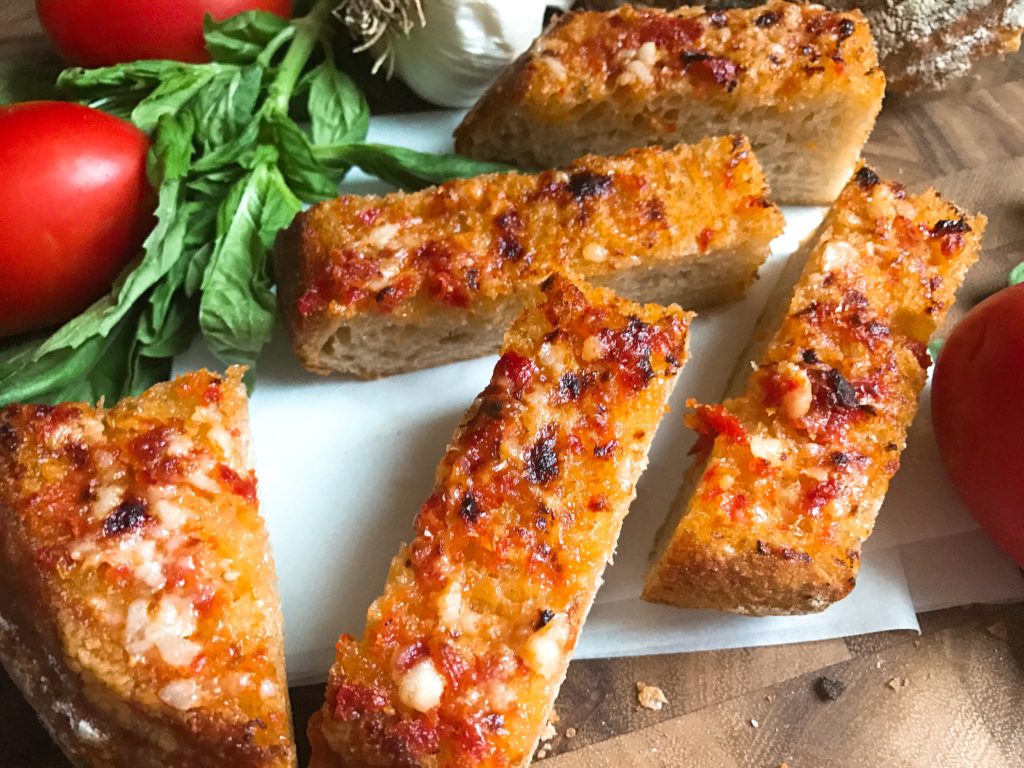 Ready in less than 10 minutes, this Pan con Tomate Garlic Bread is inspired by the classic Pan con Tomate dish in Spain. Tomato and garlic are the stars of this unique bread, perfect as an appetizer, snack, or side for Italian dishes. Inspired by my vacation to Barcelona, this garlic bread is full of flavor. Fast and easy to make! Three Olives Branch | www.threeolivesbranch.com