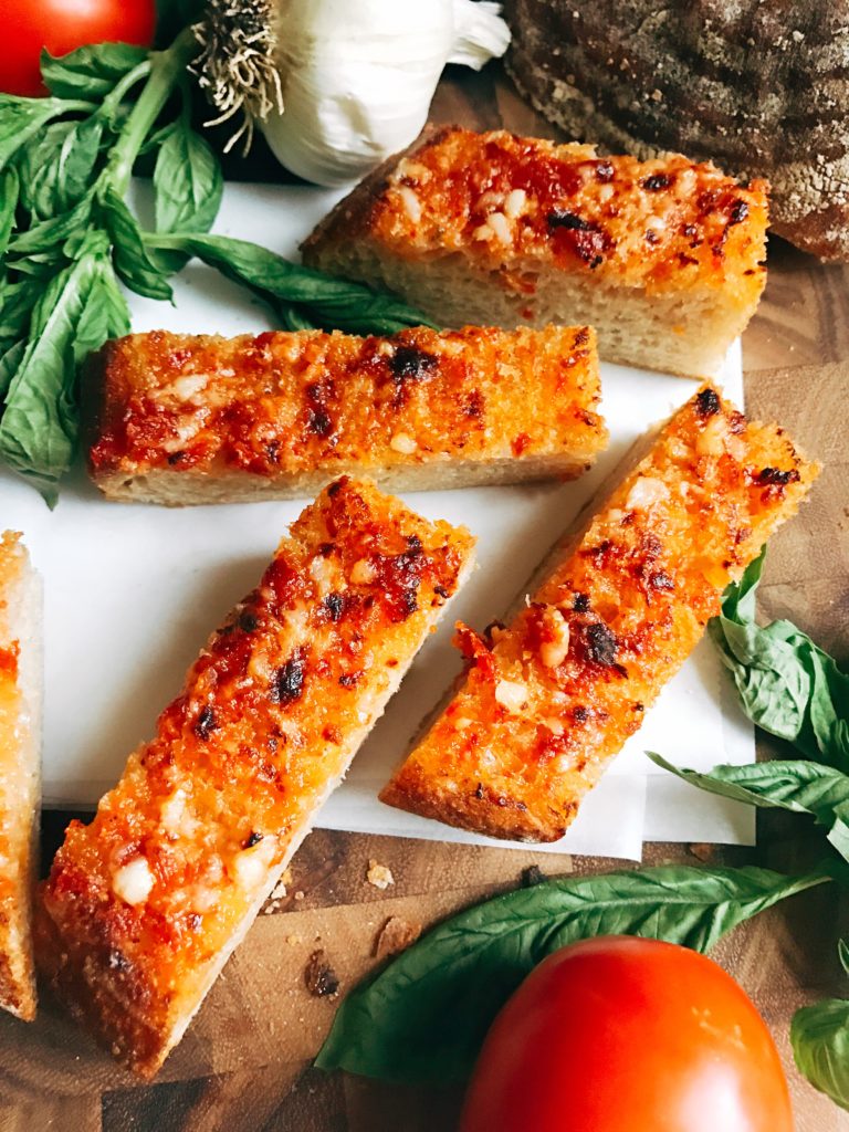 Ready in less than 10 minutes, this Pan con Tomate Garlic Bread is inspired by the classic Pan con Tomate dish in Spain. Tomato and garlic are the stars of this unique bread, perfect as an appetizer, snack, or side for Italian dishes. Inspired by my vacation to Barcelona, this garlic bread is full of flavor. Fast and easy to make! Three Olives Branch | www.threeolivesbranch.com