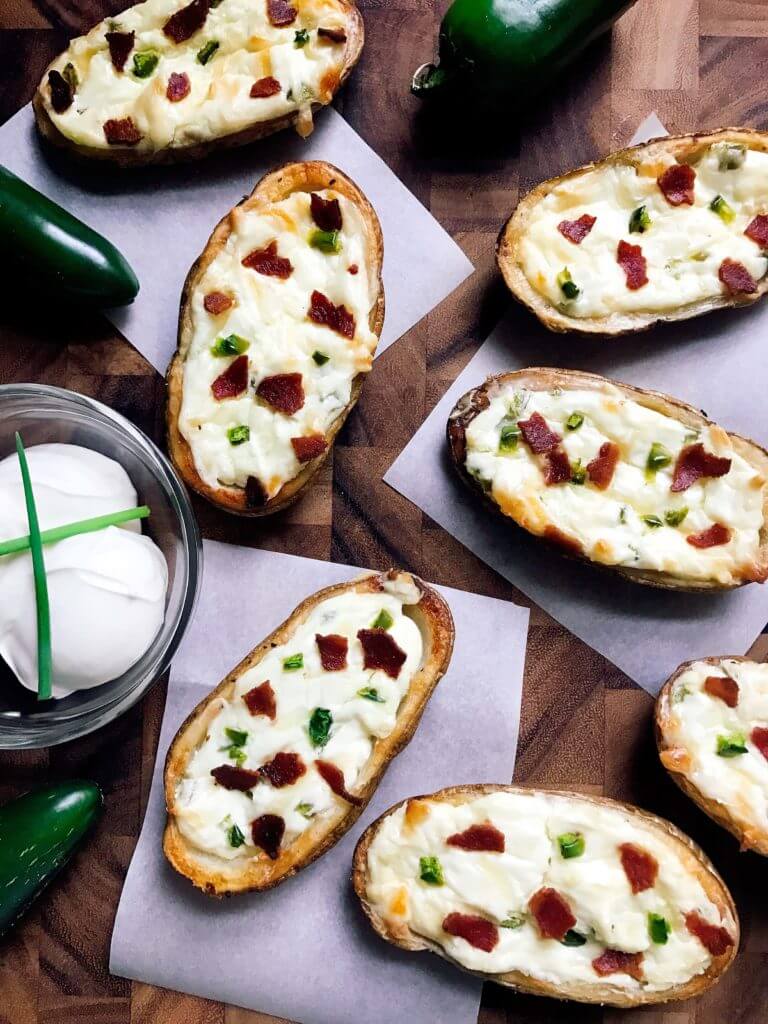 Perfect for the big game, these Jalapeno Popper Potato Skins are one of our favorites! Control the spicy heat level with the amount of jalapeno you use and this is perfect as an appetizer, especially for football games! Easy to make and vegetarian friendly. Three Olives Branch | www.threeolivesbranch.com 