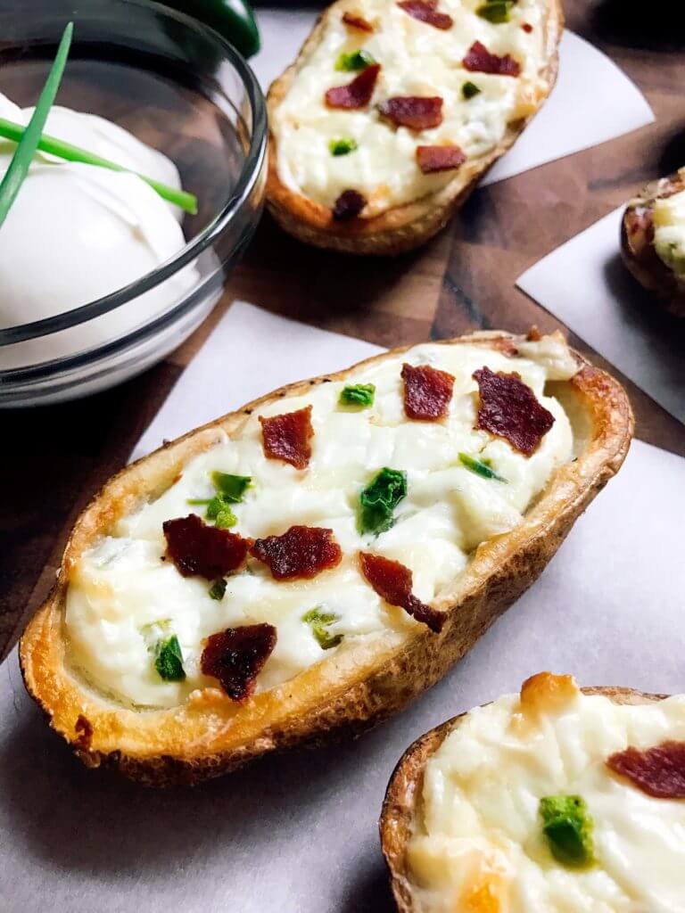 Perfect for the big game, these Jalapeno Popper Potato Skins are one of our favorites! Control the spicy heat level with the amount of jalapeno you use and this is perfect as an appetizer, especially for football games! Easy to make and vegetarian friendly. Three Olives Branch | www.threeolivesbranch.com 