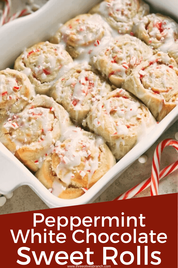 Pin image for a white tray full of Peppermint White Chocolate Sweet Rolls (Cinnamon Rolls) surrounded by candy canes with title at bottom