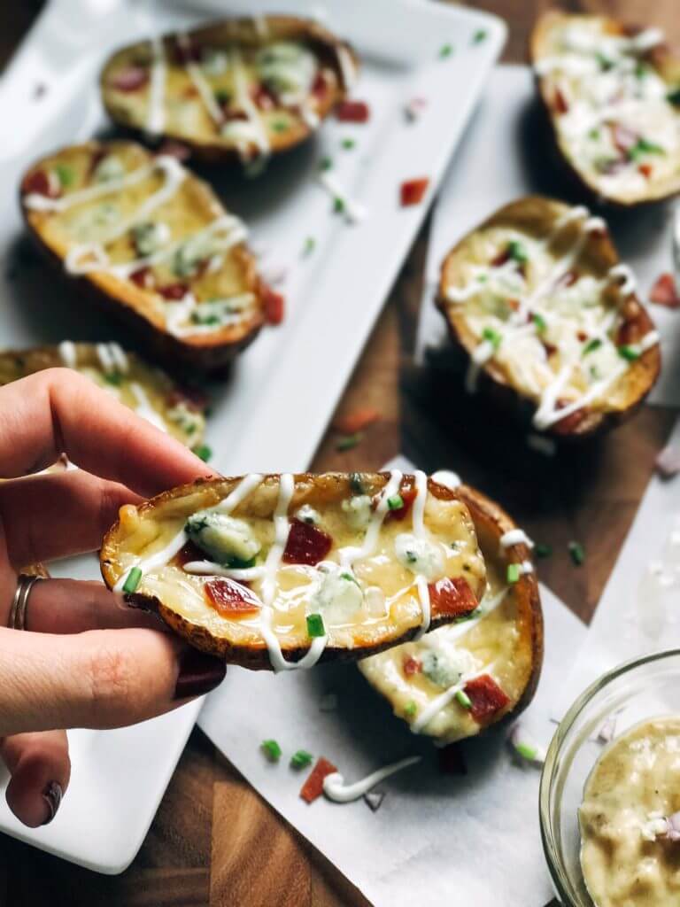 A hand holding a potato skin