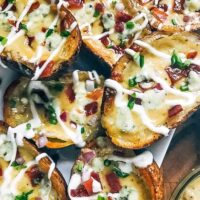 A pile of Bacon and Bourbon Blue Cheese Potato Skins