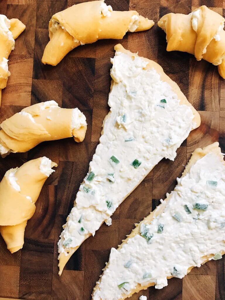 Process shot of Jalapeno Popper Crescent Rolls being filled and rolled