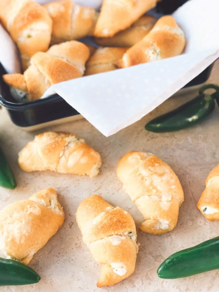 Jalapeno Popper Crescent Rolls on a counter and some in a dish