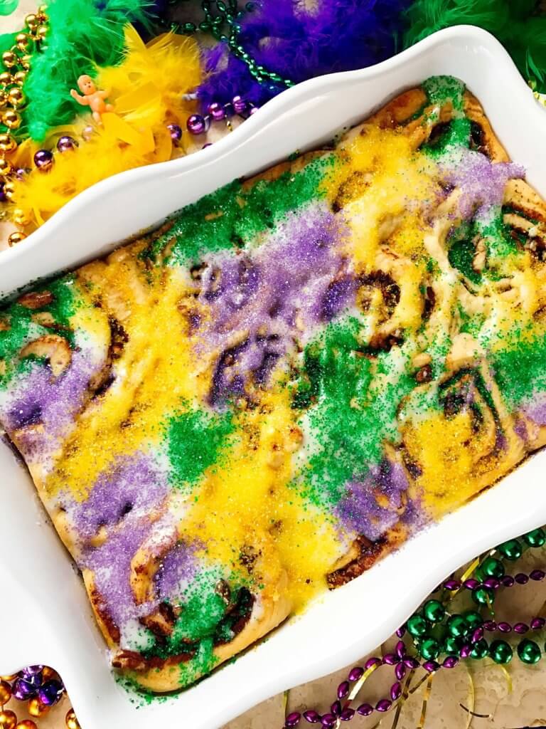 Make in advance for an easy breakfast! Comfort food perfect for the holiday. Vegetarian and kid friendly. Pecan, cinnamon, and flaky dough. Mardi Gras King Cake Cinnamon Rolls | Three Olives Branch | www.threeolivesbranch.com