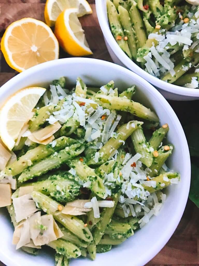 Less than 15 minutes, this light and healthy dish is ready! Perfect for busy nights, full of nutrition, and a great way to sneak healthy food into a meal. Vegetarian or add chicken, sausage, or shrimp for meat lovers. Fast, simple, and easy to make. Great for spring and summer lighter dishes. Spinach Artichoke Pesto Pasta | Three Olives Branch | www.threeolivesbranch.com