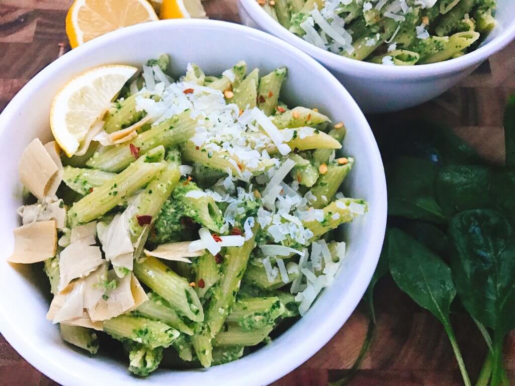 Less than 15 minutes, this light and healthy dish is ready! Perfect for busy nights, full of nutrition, and a great way to sneak healthy food into a meal. Vegetarian or add chicken, sausage, or shrimp for meat lovers. Fast, simple, and easy to make. Great for spring and summer lighter dishes. Spinach Artichoke Pesto Pasta | Three Olives Branch | www.threeolivesbranch.com