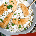 Pin of top view of Copycat Olive Garden Chicken Fettuccine Alfredo in a dish with title at bottom