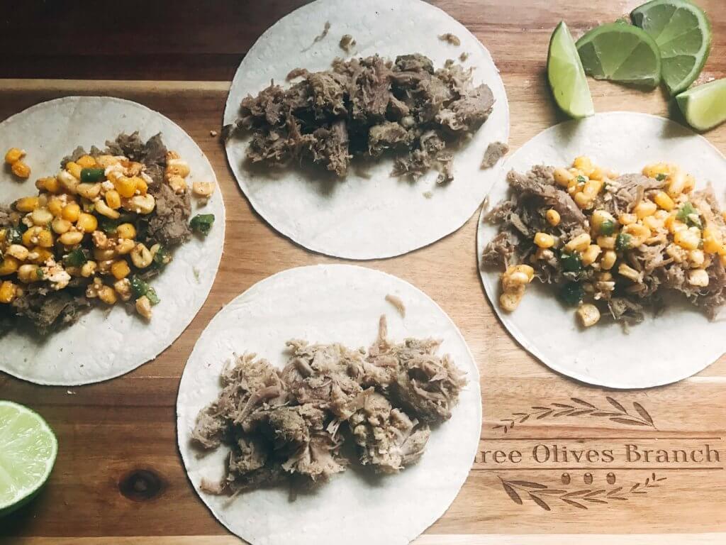 Less than 30 minutes for these fast and simple tacos! Easy to make and perfect for leftovers. Fresh corn salsa pairs perfectly with the seasoned pork. Pork Carnitas Mexican Street Corn Tacos | Three Olives Branch | www.threeolivesbranch.com