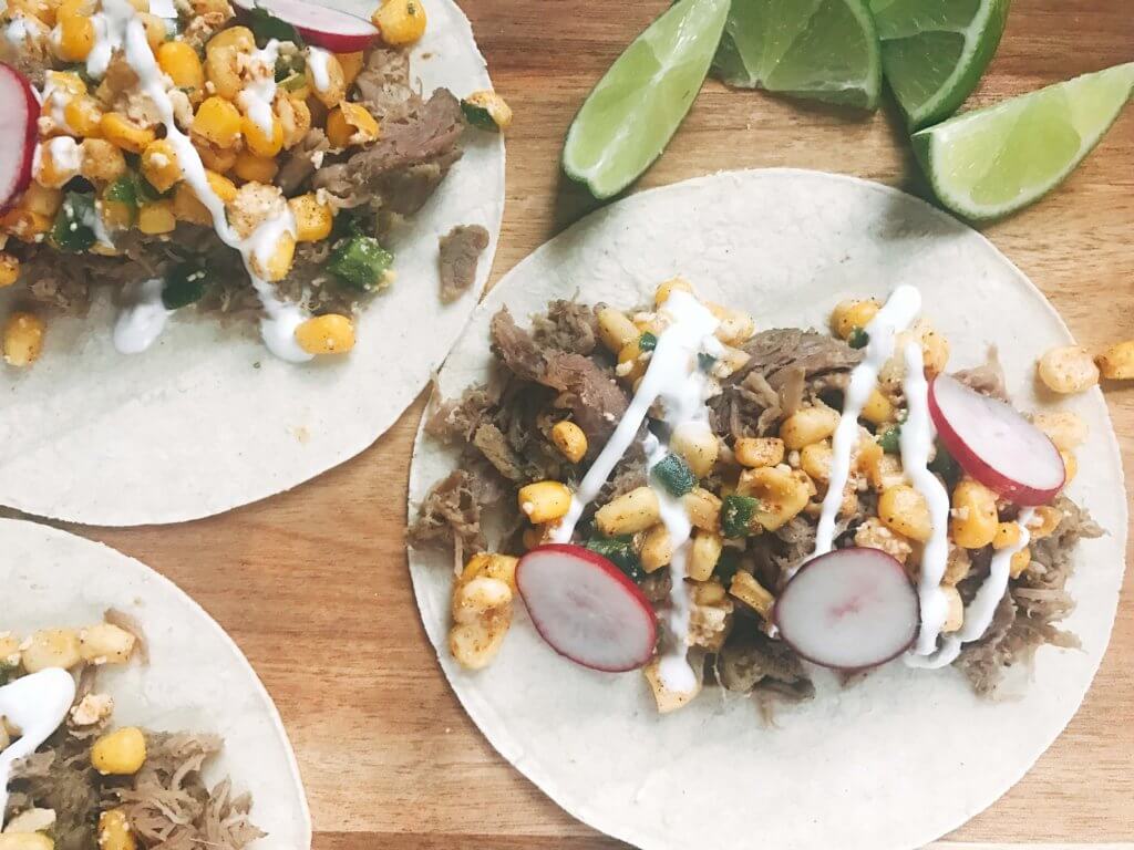 Less than 30 minutes for these fast and simple tacos! Easy to make and perfect for leftovers. Fresh corn salsa pairs perfectly with the seasoned pork. Pork Carnitas Mexican Street Corn Tacos | Three Olives Branch | www.threeolivesbranch.com