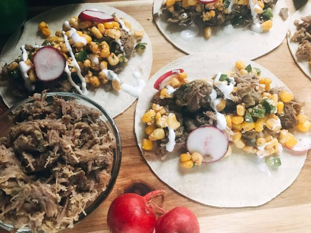 Less than 30 minutes for these fast and simple tacos! Easy to make and perfect for leftovers. Fresh corn salsa pairs perfectly with the seasoned pork. Pork Carnitas Mexican Street Corn Tacos | Three Olives Branch | www.threeolivesbranch.com