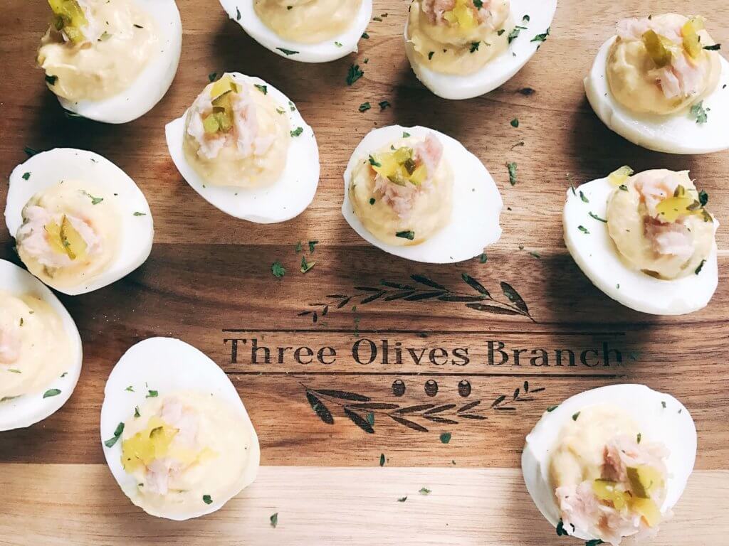 Ready in 10 minutes, fast and simple deviled eggs with unique flavors similar to tuna salad. Tuna, relish, mayo, and mustard brighten up these eggs for a unique appetizer or snack. Great for any party, event, game, or holiday like Easter. Tuna Luna Deviled Eggs | Three Olives Branch | www.threeolivesbranch.com