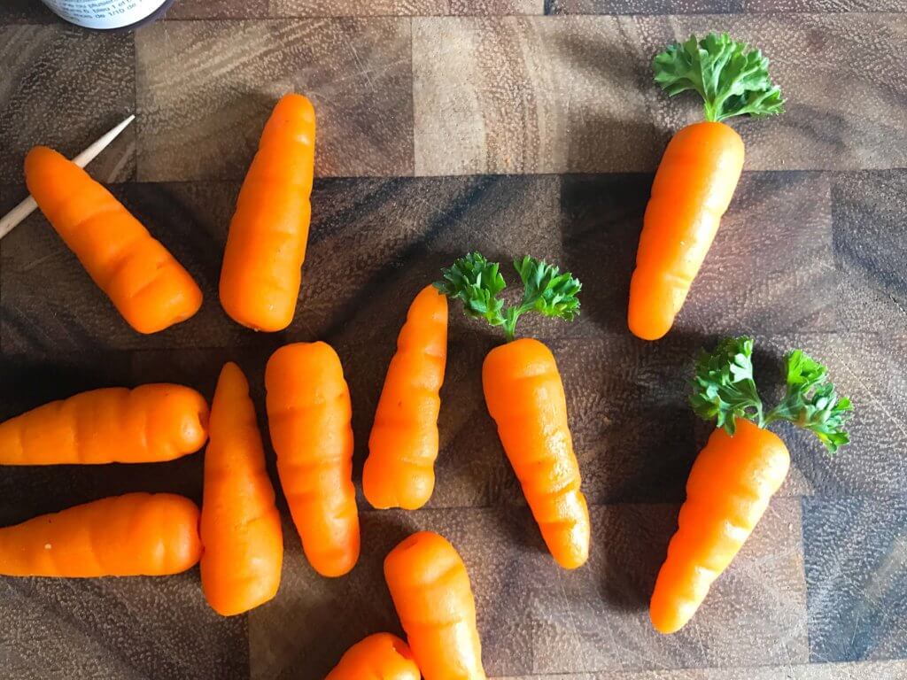 In 10 minutes you can have these adorable marzipan carrots ready for your Easter or spring celebration! Vegan and completely edible, they are a fun and festive decoration for the holiday that you can use on anything. Fast, simple, and easy way to add some flair to your event. How to Make Marzipan Carrots | Three Olives Branch | www.threeolivesbranch.com