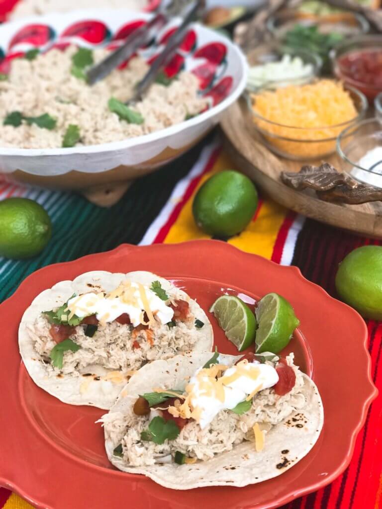 Quick and easy slow cooker chicken is perfect for tacos, enchiladas, and more! Serve it up as an easy taco bar, perfect for your guests and entertaining at parties and Cinco de Mayo. Green chiles, onion, cumin, and Corona beer are a perfect flavor combination for light and delicious tacos or Mexican food. Simple and fast to put together. Slow Cooker Mexican Beer Chicken | Three Olives Branch | www.threeolivesbranch.com