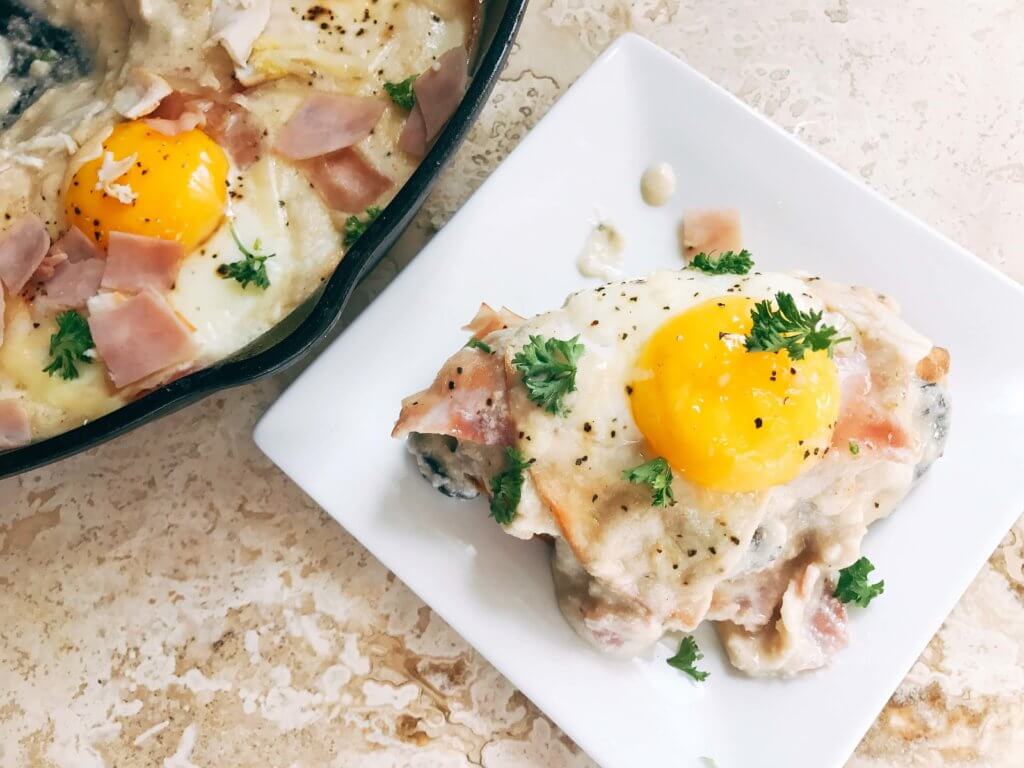 Great for spring entertaining, this dish is perfect for any meal of the day. Breakfast, brunch, lunch, or dinner, classic flavors of Chicken Cordon Bleu are combined with the style of shakshuka. Ham, chicken, cheese sauce, and eggs. Can be served on a piece of grilled chicken, bread, or eat it straight! Fast and simple to make, perfect for entertaining and parties. A great start to holiday mornings. Chicken Cordon Bleu Shakshuka | Three Olives Branch | www.threeolivesbranch.com