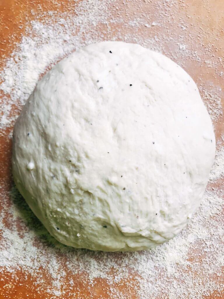 Homemade pizza dough makes every pizza special! This fresh dough is simple and can be made in advance for a quick pizza night. Freezes well! Vegetarian, kid friendly, and delicious. Makes two 12" thin pizza crusts. Parmesan Black Pepper Pizza Dough | Three Olives Branch | www.threeolivesbranch.com