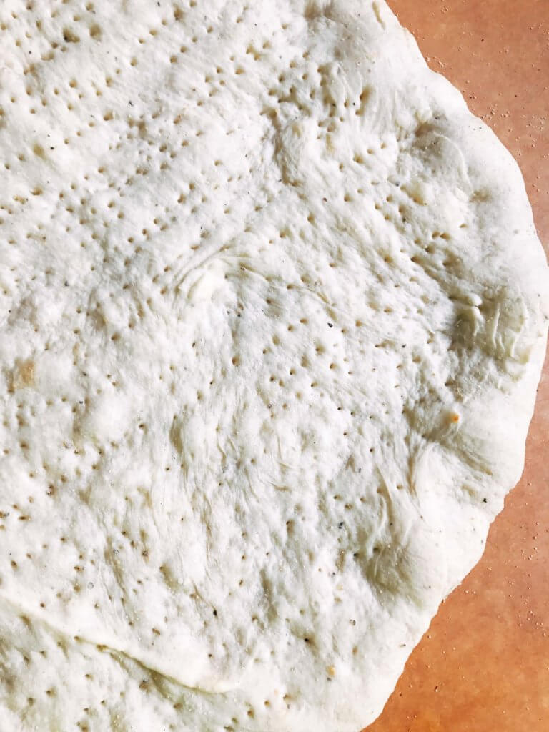 Homemade pizza dough makes every pizza special! This fresh dough is simple and can be made in advance for a quick pizza night. Freezes well! Vegetarian, kid friendly, and delicious. Makes two 12" thin pizza crusts. Parmesan Black Pepper Pizza Dough | Three Olives Branch | www.threeolivesbranch.com