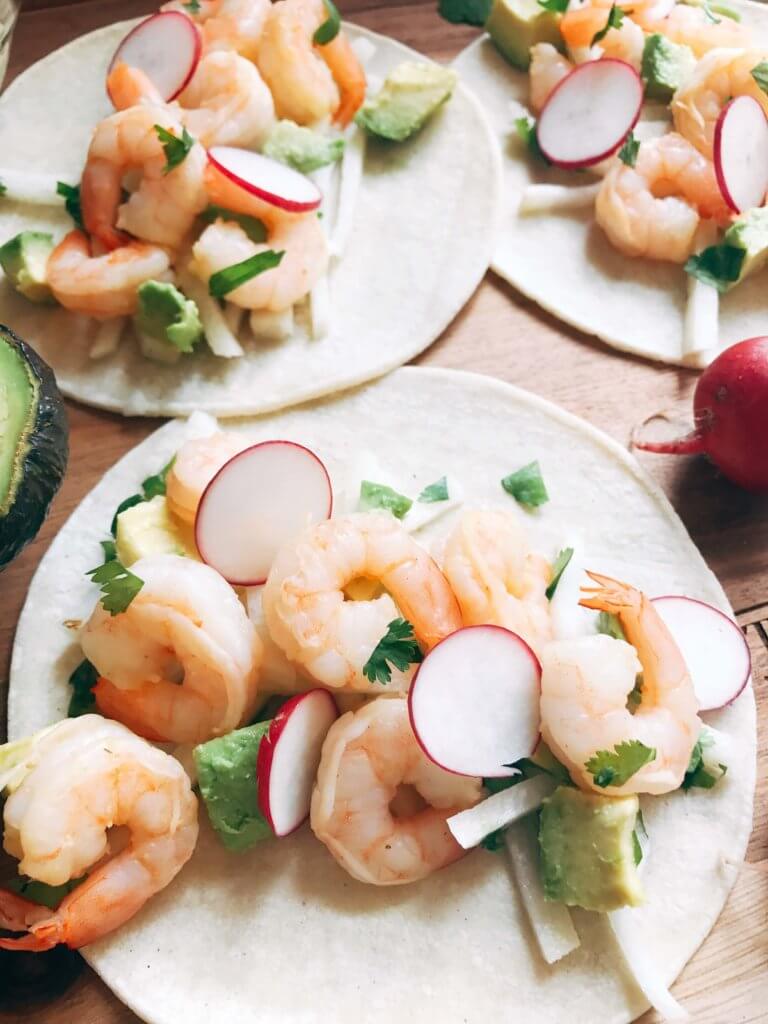 Less than 30 minutes for these simple and fresh shrimp tacos. Perfect for on-the-go food, full of bright and fresh flavors. Shrimp, orange, grapefruit, avocado, and jicama inspired by Aquafina Sparkling Water. A great twist on a seafood taco for Mexican night. Quick and easy to make, perfect for summer. Grapefruit Orange Shrimp Tacos with Jicama Slaw | Three Olives Branch | www.threeolivesbranch.com