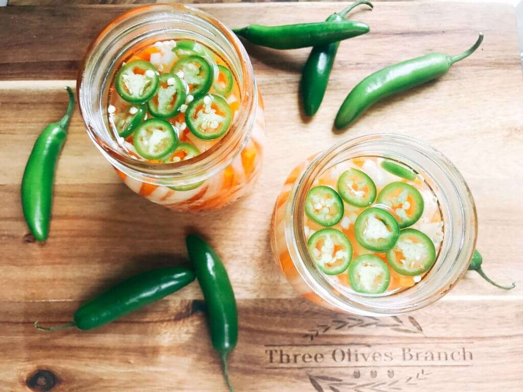 Simple and easy Spicy Vietnamese Pickled Vegetables perfect for your banh mi! Use as a quick condiment on your favorite foods. Quick refrigerator pickle of daikon radish and carrots are made spicy with serrano. A rice vinegar base is ready in just minutes for this classic Vietnamese slaw. Use cucumber or your favorite vegetables. Vegan, gluten free, and vegetarian. #pickled #banhmi #vietnamese