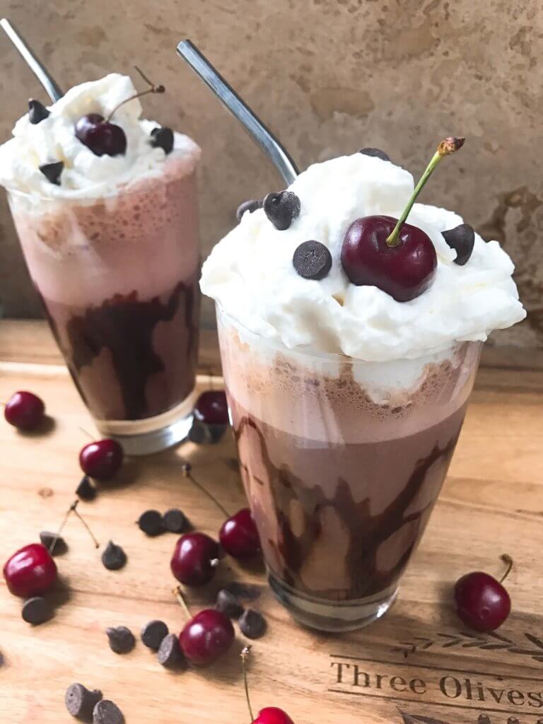 A perfect coffee drink for the summer and warm weather! Ready in just minutes, this frozen coffee can also be made as an iced coffee. Classic Black Forest dessert flavors of cream, cherries, and chocolate are paired with coffee for a fun treat. Simple and easy to make, vegetarian. Frozen Black Forest Mocha Coffee | Three Olives Branch | www.threeolivesbranch.com