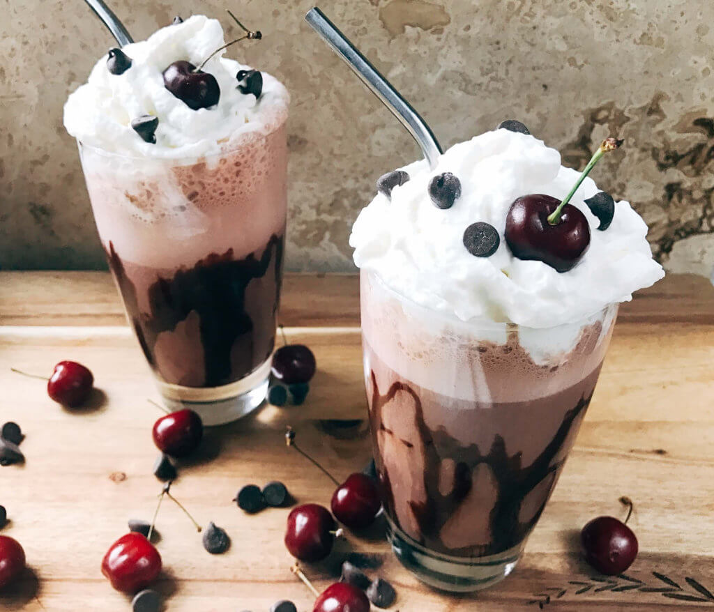 A perfect coffee drink for the summer and warm weather! Ready in just minutes, this frozen coffee can also be made as an iced coffee. Classic Black Forest dessert flavors of cream, cherries, and chocolate are paired with coffee for a fun treat. Simple and easy to make, vegetarian. Frozen Black Forest Mocha Coffee | Three Olives Branch | www.threeolivesbranch.com