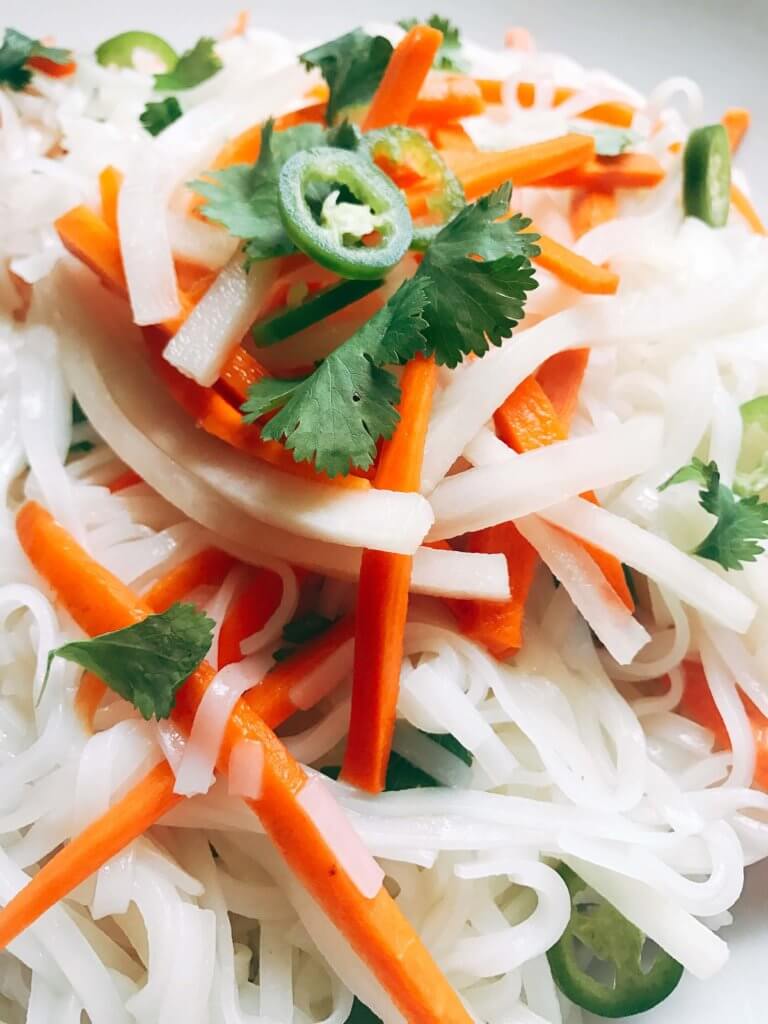 A simple and fast gluten free side dish that is perfect for summer grilling and entertaining. Vegan and vegetarian, this noodle salad is easy to make and a great fresh addition to a BBQ or party like the 4th of July or Father's Day. Add some tofu, chicken, or shrimp for a full dinner meal. Pickled carrots and daikon radish in a rice vinegar bright a fresh brightness and acidity. Make it spicy with some serrano or jalapeno. Vietnamese Pickled Vegetable Rice Noodle Salad | Three Olives Branch | www.threeolivesbranch.com