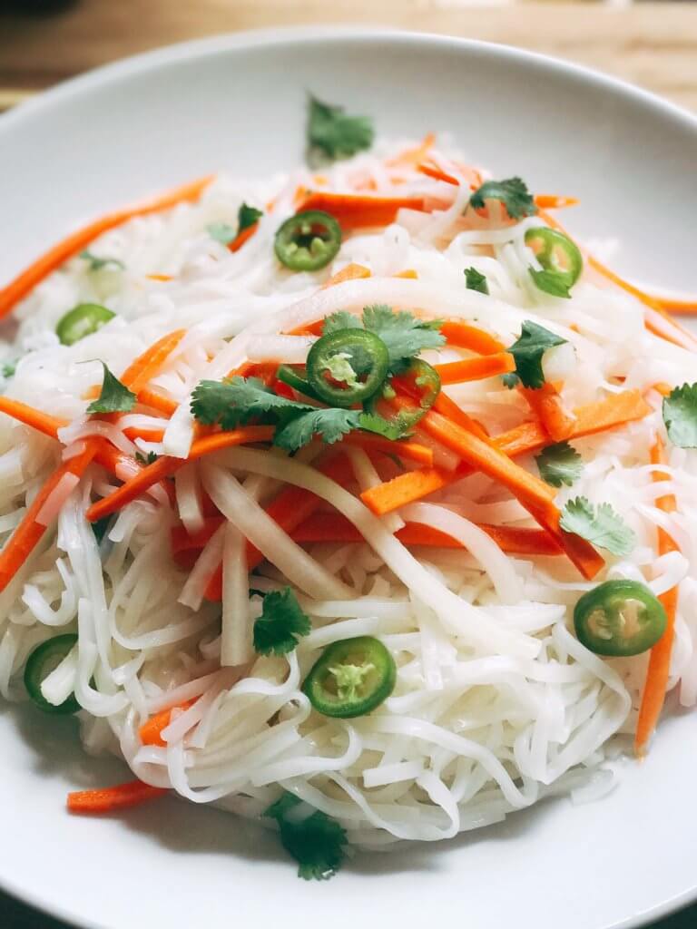 A simple and fast gluten free side dish that is perfect for summer grilling and entertaining. Vegan and vegetarian, this noodle salad is easy to make and a great fresh addition to a BBQ or party like the 4th of July or Father's Day. Add some tofu, chicken, or shrimp for a full dinner meal. Pickled carrots and daikon radish in a rice vinegar bright a fresh brightness and acidity. Make it spicy with some serrano or jalapeno. Vietnamese Pickled Vegetable Rice Noodle Salad | Three Olives Branch | www.threeolivesbranch.com