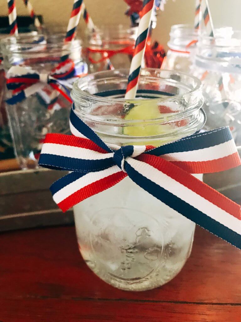 Patriotic Mason Jars for Drinks Station - Simple ideas and tips for Hosting a Patriotic Party including the menu we served! Chicken and Vegetarian Banh Mi Burgers featuring sweet chili sauce, Vietnamese Pickled Vegetable Rice Noodle Salad, BLT Panzanella, and Raspberry Rose (Frose) Popsicles. A perfect summer BBQ or grilling dinner party theme to celebrate the USA and American heritage. Hosting a Patriotic Party | Three Olives Branch | www.threeolivesbranch.com