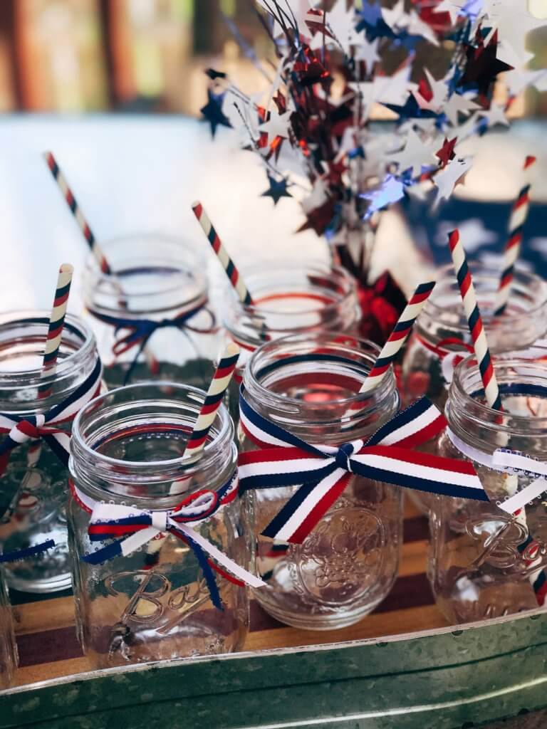Patriotic Mason Jars for Drinks - Simple ideas and tips for Hosting a Patriotic Party including the menu we served! Chicken and Vegetarian Banh Mi Burgers featuring sweet chili sauce, Vietnamese Pickled Vegetable Rice Noodle Salad, BLT Panzanella, and Raspberry Rose (Frose) Popsicles. A perfect summer BBQ or grilling dinner party theme to celebrate the USA and American heritage. Hosting a Patriotic Party | Three Olives Branch | www.threeolivesbranch.com